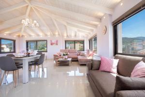 a living room with a couch and a table and chairs at Slavena Suite in Perivólia
