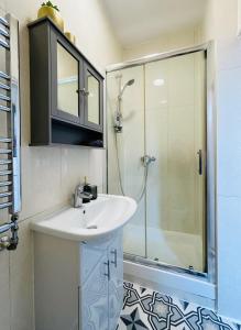 a bathroom with a sink and a shower at Apollo Hammersmith Studio in London