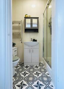 a bathroom with a sink and a toilet at Apollo Hammersmith Studio in London