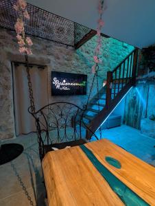 a room with a bed and a staircase with a sign at Maison Insolite avec Spa Privatif in Monbalen