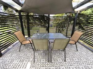 a glass table and chairs on a patio at The Other House, Piliscsaba in Piliscsaba