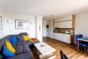 a living room with a couch and a table at Haus 7 Apartment 2 Hundefreundlich in Plau am See