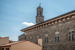 a large brick building with a clock tower at The Tower Glimpse in Florence