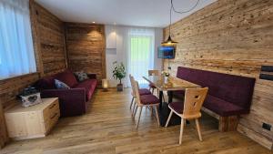salon z kanapą i stołem z krzesłami w obiekcie Apartment Pichlerhof w mieście San Lorenzo di Sebato