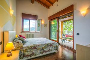 a bedroom with a bed and a large window at Villa Mavica in  Monvalle  +71 photos