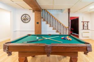 a pool table in the middle of a room at Old-Time Charm - 12 Guests - Billiards & Hot Tub in Sainte-Anne-de-Beaupré