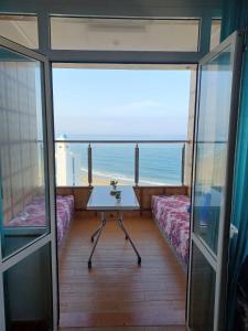 a room with a table and a view of the ocean at Miramar in M'diq +8 photos