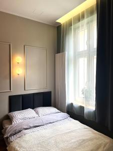 una camera da letto con un letto davanti a una finestra di GREY Apartment 1 a Poznań