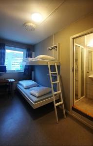a bunk bed with a ladder in a room at Bodo Motel Norway in Bodø
