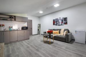 a kitchen and a living room with a couch and a table at Апарт-отель MICH8 by KEYGO in Yerevan