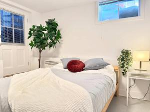 a bedroom with a bed with a red pillow on it at 4 Grandes Chambres Centre-Ville in Quebec City