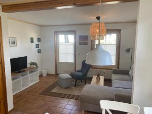 a living room with a couch and a tv at ökologische Ferienanlage in Bansin