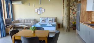 a living room with a bed and a table at DOLPHIN BAY BOUTIQUE COMPLEX Sozopol in Sozopol