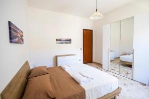 a bedroom with a large bed and a mirror at Casa Cloe Mondello in Palermo