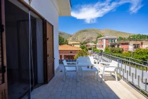 a balcony with a table and chairs and a mountain at Casa Cloe Mondello in Palermo