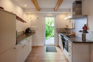 a kitchen with a sink and a stove top oven at Ferienhaus Lauwenhaus mit Sauna und eingezäunten Garten in Braunlage