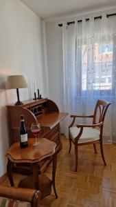 a living room with a table and a glass of wine at Merziger Fußgängerzone in Merzig +12 photos
