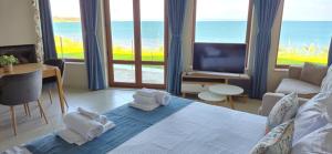 a bedroom with a bed with towels on it at DOLPHIN BAY BOUTIQUE COMPLEX Sozopol in Sozopol