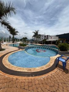 a large swimming pool with a blue bench next to it at Flat in Tatu City Unity one in Tatu City