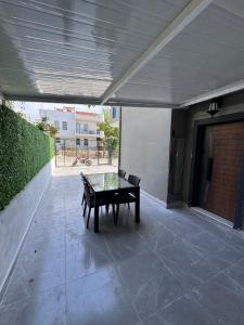 a patio with a table and chairs in a building at Holiday Home in Stylish and Peaceful Center in Kusadası