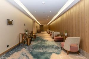 a long corridor with chairs and tables in a room at Casa Diora Hotel Al Rawdah in Jeddah