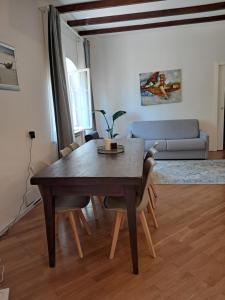 a dining room table and chairs in a living room at Holiday Inn Mirida in Pesaro
