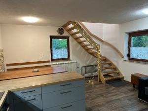 a kitchen with a spiral staircase in a room at Krtajse in Slap ob Idrijci +18 photos