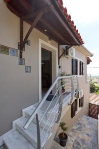 a staircase leading up to a house with a balcony at Pelion PNOES Luxury Seaview Villa with priv Garden in Káto Lekhónia