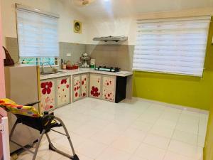 a kitchen with a sink and a counter top at iLham Homestay in Kangar