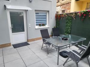 a patio with a table and chairs and a window at Soukromý apartmán Deluxe in Trutnov +8 photos