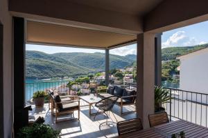 a balcony with a view of the mountains at Apartment Stella in Rabac