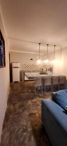 a living room with a table and chairs in it at Casa Fundo de Quintal in Baía Formosa