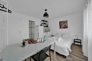 a white bedroom with a bed and a desk at PEARL02 Pearl Arbor Studio 2 in Pieterlen