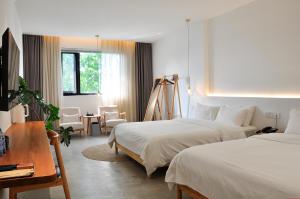 Postel nebo postele na pokoji v ubytování Xingle Hotel-Suzhou Guanqian Street Pingjiang Road
