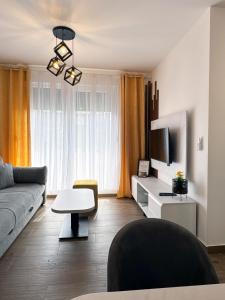 a living room with a couch and a tv at Moj Mir in Vrnjačka Banja