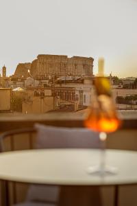 a table with a view of a city at Room Mate Collection Mia, Rome Colosseum in Rome