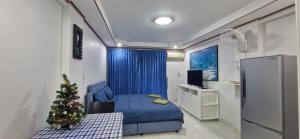 a small christmas tree in a room with a bed at Rawai Condotel 3 in Rawai Beach