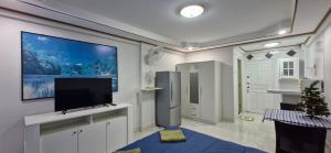 a kitchen with a flat screen tv on a wall at Rawai Condotel 3 in Rawai Beach +95 photos