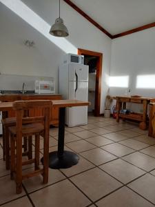 a kitchen with a table and a refrigerator at Casaquinta La Morena in Azul