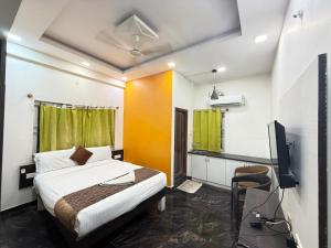 a bedroom with a bed and a television in it at SUPREME SUITs in Jāmb +19 photos