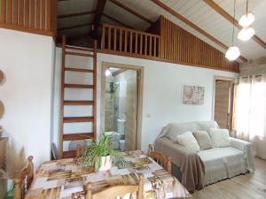 a living room with a table and a couch at A Feitiña de Rubiacós in Rubiacós +37 photos