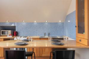 a kitchen with a table with plates and glasses at Newton House - Free Parking in Whitby
