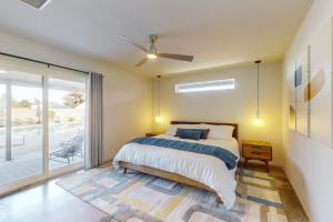 a bedroom with a bed and a sliding glass door at The Chandler Hideaway - Main House Only in Chandler +41 photos