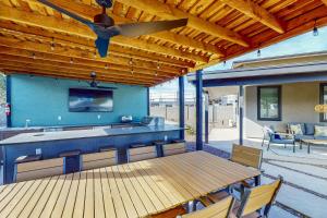 a patio with a table and a ceiling fan at The Chandler Hideaway - Main House Only in Chandler