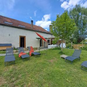 a group of chairs in the yard of a house at Gîte Coume a Case, Pyrénées Atlantiques in Lys