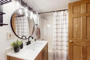 a bathroom with a sink and a mirror at Maine Lake Family Retreat in Monmouth +11 photos