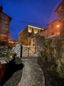 a stone house with a gate in front of it at En si bon chemin - Gîte chemin 430 in Le Monastier sur Gazeille