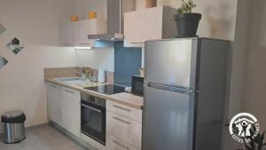 a kitchen with a stainless steel refrigerator and a sink at Le rodin in Albi +14 photos