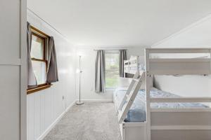 a bedroom with two bunk beds and a window at Cozy Dennis Retreat in Bridgewater