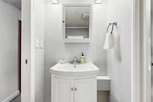 a white bathroom with a sink and a mirror at Cozy Dennis Retreat in Bridgewater +58 photos